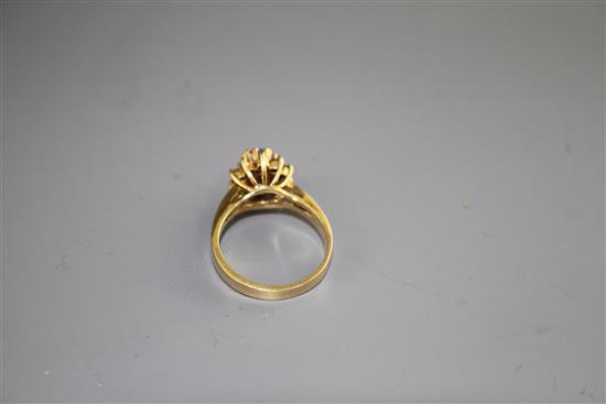 A modern 18k yellow metal, chrysoberyl? and diamond set oval cluster ring, size M, gross weight 4.2 grams.